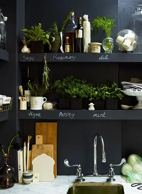 Herb garden display with colorful plant markers and decorative stones